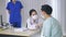 Doctor in conversation with patient wearing mask