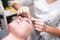 Doctor cosmetologist does facial cosmetology massage and massaging eyebrow area