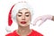 The doctor cosmetologist makes the Botox injection procedure on the face skin of a beautiful woman in the Santa Claus hat