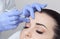 The doctor cosmetologist makes the Rejuvenating facial injections procedure for tightening and smoothing wrinkles on the face skin