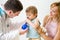 Doctor counseling mother and child about nasal irrigation or douch