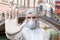 Doctor in coveralls warns of coronavirus infection in Venice in Italy.