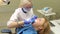 Doctor dentist drills tooth in clinic of dentistry