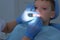 Doctor dentist hygienist applying fluoride to teen boy teeth with brush.