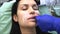 Doctor dermatologist cosmetologist performs lips massage after contour plastic