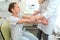 Doctor dermatologist makes the initial examination of the skin of the hands of a child