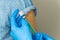 doctor dials the vaccine into a syringe. a nurse with a vaccine and a syringe in her hands