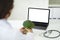 Doctor dietician have online consultation, using laptop, holding broccoli