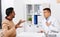 Doctor and displeased male patient argue at clinic