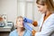 Doctor dripping eye drops on eyes of a senior patient