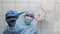 A doctor with an enema in his hands stands above the patient.