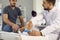 Doctor examine patient with broken leg in orthopedic bandage on hospital bed