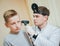 Doctor examines boy ear with otoscope. Medical equipment.
