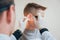 Doctor examines boy ear with otoscope. Medical equipment.