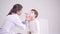 Doctor examines the throat of a small patient. 7 years old boy, medical checkup