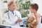 Doctor examines, young boy wearing a blue cast