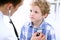 Doctor examining a child patient by stethoscope