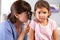 Doctor Examining Child\'s Ears In Doctor\'s Office