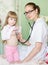 Doctor examining girl with stethoscope