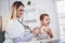 Doctor examining a little boy by stethoscope