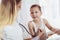 Doctor examining a little boy by stethoscope