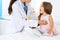 Doctor examining a little girl by stethoscope