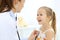 Doctor examining a little girl by stethoscope. Happy smiling child patient at usual medical inspection. Medicine and