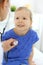 Doctor examining a little girl by stethoscope. Happy smiling child patient at usual medical inspection. Medicine and