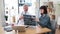 Doctor examining MRI scans while woman sitting at desk