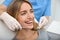 Doctor examining patient`s teeth in clinic, closeup. Cosmetic dentistry