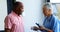 Doctor explaining about blood pressure monitor to senior man 4k