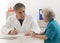 Doctor explaining diagnosis to his senior female patient