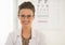 Doctor in eyeglasses in front of snellen chart