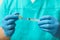 Doctor filling syringe with hepatitis vaccine from glass vial, closeup