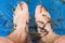 Doctor fish cleaning male feet in a spa