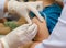 Doctor give injection of vaccine to boy\'s arm