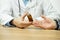 Doctor is giving bottle of pills to an old female patient