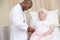 Doctor giving checkup to woman in exam room