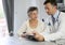 Doctor giving a medical prescription to an elderly woman