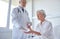 Doctor giving medicine to senior woman at hospital