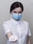 Doctor giving pills, woman in medical mask and gloves. The concept of the dose of drugs, vitamins, medical examination,