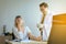 Doctor giving vaccine to women patient with injection or syringe in hospital room