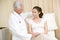 Doctor giving woman checkup in exam room