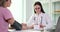 Doctor in glasses measures blood pressure of lady patient