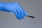 Doctor in gloves holding a scalpel