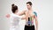 The doctor glues a special treatment tape to mail shoulder. Physiotherapist sticks kinesio tapes to the shoulder of