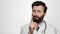 Doctor good idea. Concentrated man doctor on white background with pensive face lifts his index finger up to show that