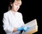 Doctor in gown and rubber gloves reading a medical book to confirm that his patient is in excellent health