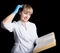 Doctor in gown and rubber gloves reading a medical book to confirm that his patient is in excellent health