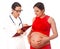 Doctor gynecologist giving consultation to a young pregnant woman